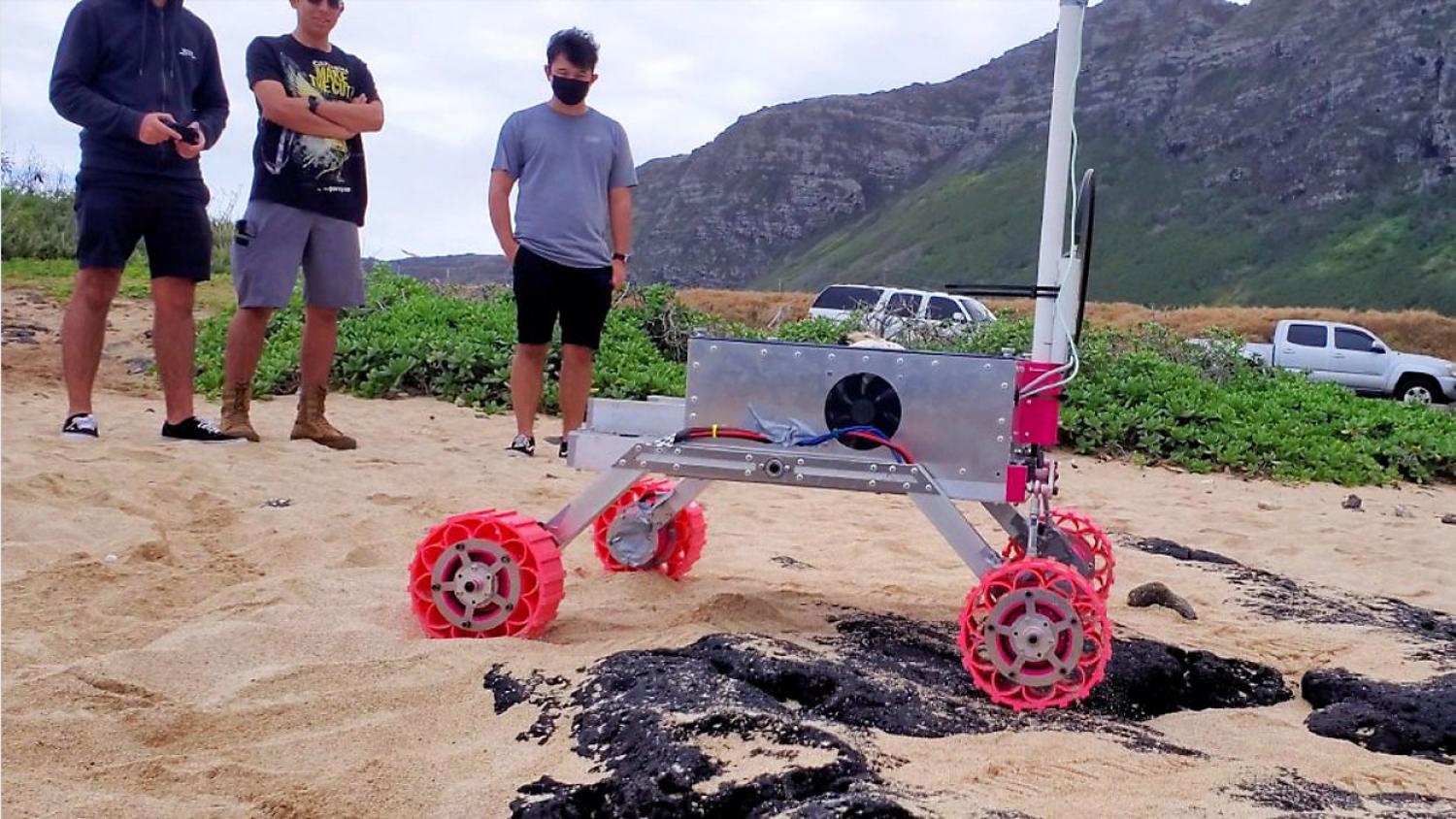 Team RoSE in the field testing their robotic rover for a possible mission to Mars.